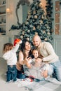 Miling young family in Christmas atmosphere making photo with smartphone Royalty Free Stock Photo