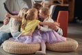 A young happy family in a hug while playing at home together. Family, home, playing, togetherness
