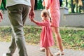 Young happy family with little beautiful baby with blue eyes walking in summer park at sunset. Mom and little daughter Royalty Free Stock Photo