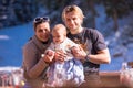 Young happy family with little child enjoying winter day Royalty Free Stock Photo