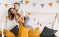 Young happy family loving mother and her child son having fun together at home, playing and laughing Royalty Free Stock Photo