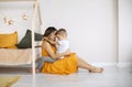 Young happy family loving mother and her child son having fun together at home, playing and laughing Royalty Free Stock Photo