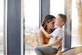 Young happy family loving mother and her child son having fun together at home, playing and laughing Royalty Free Stock Photo