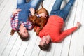 Young happy family playing with their puppy. Royalty Free Stock Photo