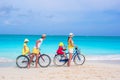 Young happy family riding bicycles duting beach Royalty Free Stock Photo