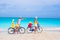 Young happy family riding bicycles duting beach Royalty Free Stock Photo