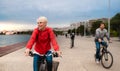 Young family riding bicycles outdoors on beach. Royalty Free Stock Photo