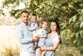 Young happy family with two children in nature in the summer walk. Healthy Smiling Dad, Mom and kids together Royalty Free Stock Photo