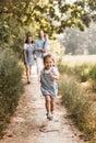 Young happy family with two children in nature in the summer walk. Healthy Smiling Dad, Mom and kids together Royalty Free Stock Photo
