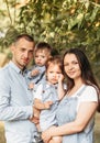 Young happy family with two children in nature in the summer walk. Healthy Smiling Dad, Mom and kids together Royalty Free Stock Photo