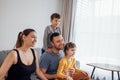 Young happy family with two children is watching television Royalty Free Stock Photo