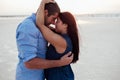 Young happy family walking along the seashore. Pregnant. Long hair. Royalty Free Stock Photo