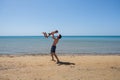 Young happy father holding up in his arms little son putting him up at the beach. Royalty Free Stock Photo