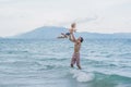 Young happy father holding up in his arms little son putting him Royalty Free Stock Photo