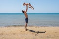 Young happy father holding up in his arms little son putting him up at the beach. Royalty Free Stock Photo