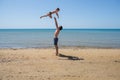 Young happy father holding up in his arms little son putting him up at the beach. Royalty Free Stock Photo