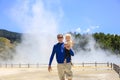 Young happy father with little daughter . Wai-O-Tapu thermal ar