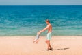 Young happy father playing with his baby at the beach Royalty Free Stock Photo