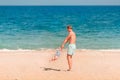 Young happy father playing with his baby at the beach Royalty Free Stock Photo