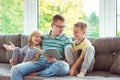 Young happy father reading book with cute children at home Royalty Free Stock Photo