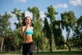 Young happy female runner running in city park. Healthy fitness woman jogging outdoors Royalty Free Stock Photo