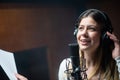 Young happy female singer or radio host working in studio Royalty Free Stock Photo