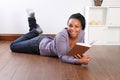 Young happy female student reading book at home Royalty Free Stock Photo