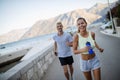 Happy young fit people couple running outdoor Royalty Free Stock Photo