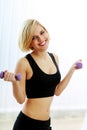 Young happy fit woman with dumbbells Royalty Free Stock Photo