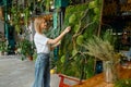 Young happy florist decorator creating plant moss panel Royalty Free Stock Photo