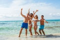 Young happy friends havin fun on the beach