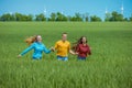 Young happy Friends running on green wheat field Royalty Free Stock Photo