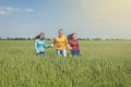 Young happy Friends running on green wheat field Royalty Free Stock Photo