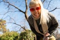 Young happy funny hippie girl showing tongue at camera for fun and making funny faces while wearing cool sunglasses. Attractive