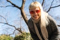 Young happy funny hippie girl showing tongue at camera for fun and making funny faces while wearing cool sunglasses. Attractive