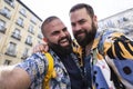 Young happy gay couple taking a self portrait together outdoors Royalty Free Stock Photo