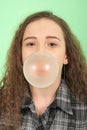 Young happy girl blowing a chewing gum Royalty Free Stock Photo