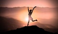 Young Happy Girl Jumps For Joy On The Top of Mountain Peak Above Clouds At Sunset. Royalty Free Stock Photo