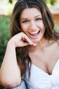 Young happy girl with long hair posing outdoor.