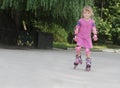 Young happy girl riding roller blades Royalty Free Stock Photo