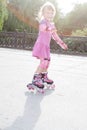 Young happy girl riding roller blades Royalty Free Stock Photo