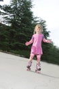 Young happy girl riding roller blades Royalty Free Stock Photo
