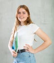 Young happy girl student hold books on gray background studio portrait. Education in high school university college Royalty Free Stock Photo