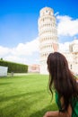 Back view of young tourist woman looking on The Leaning Tower of Pisa. Royalty Free Stock Photo