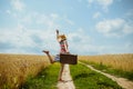 Young happy girl wearing striped dress dancing on