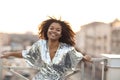 Young happy glamour african american woman with glitter on face standing on roof terrace outdoors Royalty Free Stock Photo
