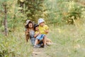 Grandmother with two grandchildren sitting on a lawn