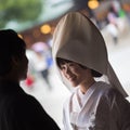 Young happy groom and bride during japanese traditional wedding ceremony at Meiji-jingu shrine in Tokyo, Japan on Royalty Free Stock Photo