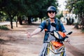 Young happy and handsome male motorcyclist riding on motorbike giving thumbs up and positive. Royalty Free Stock Photo