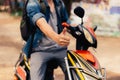 Young happy and handsome male motorcyclist riding on motorbike giving thumbs up and positive. Royalty Free Stock Photo